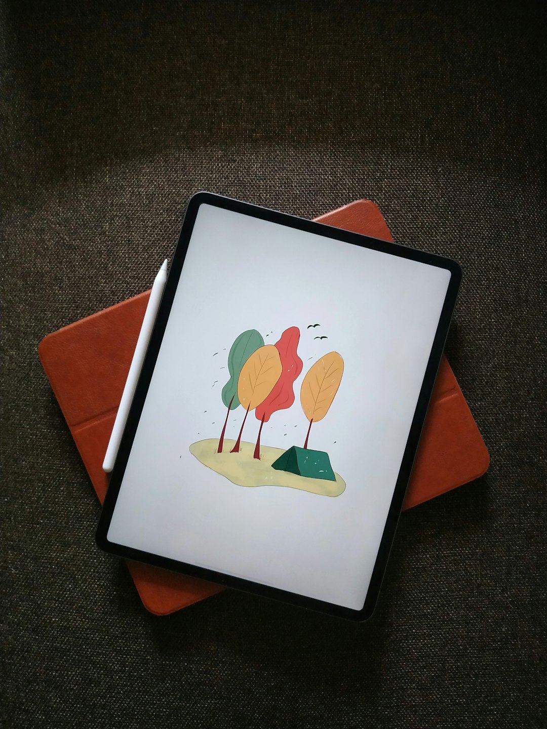 Tablet showing digital art with stylus on open case.