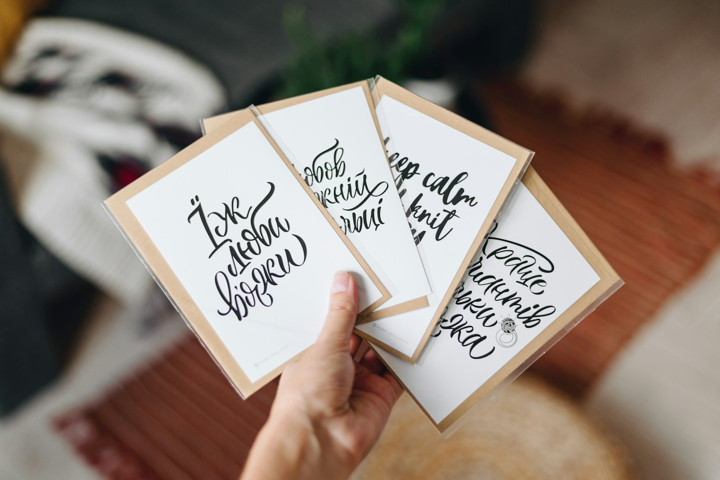 Hand holding a set of handmade greeting cards.